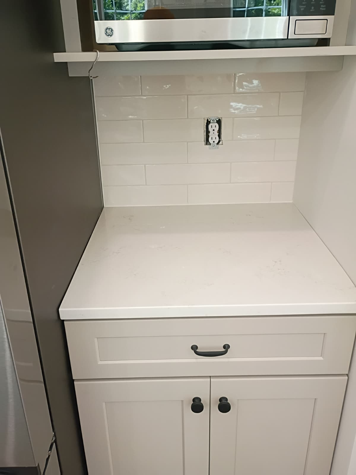 White quartz countertop, shaker lower cabinet with matte black hardware, and subway tile backsplash installed by Rvicente Remodeling LLC in Simpsonville SC