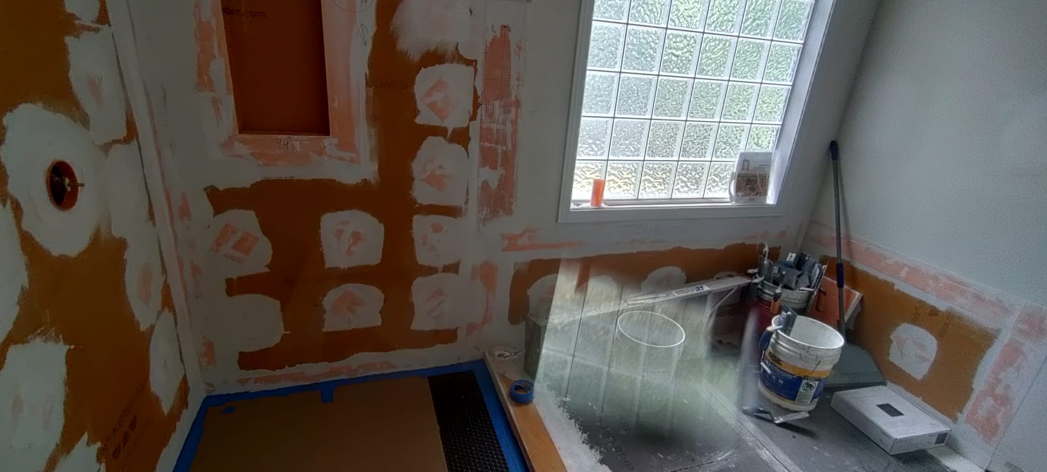 Full bathroom shower waterproofing installation next to glass block privacy window by Roberto Vicente in Greenville SC