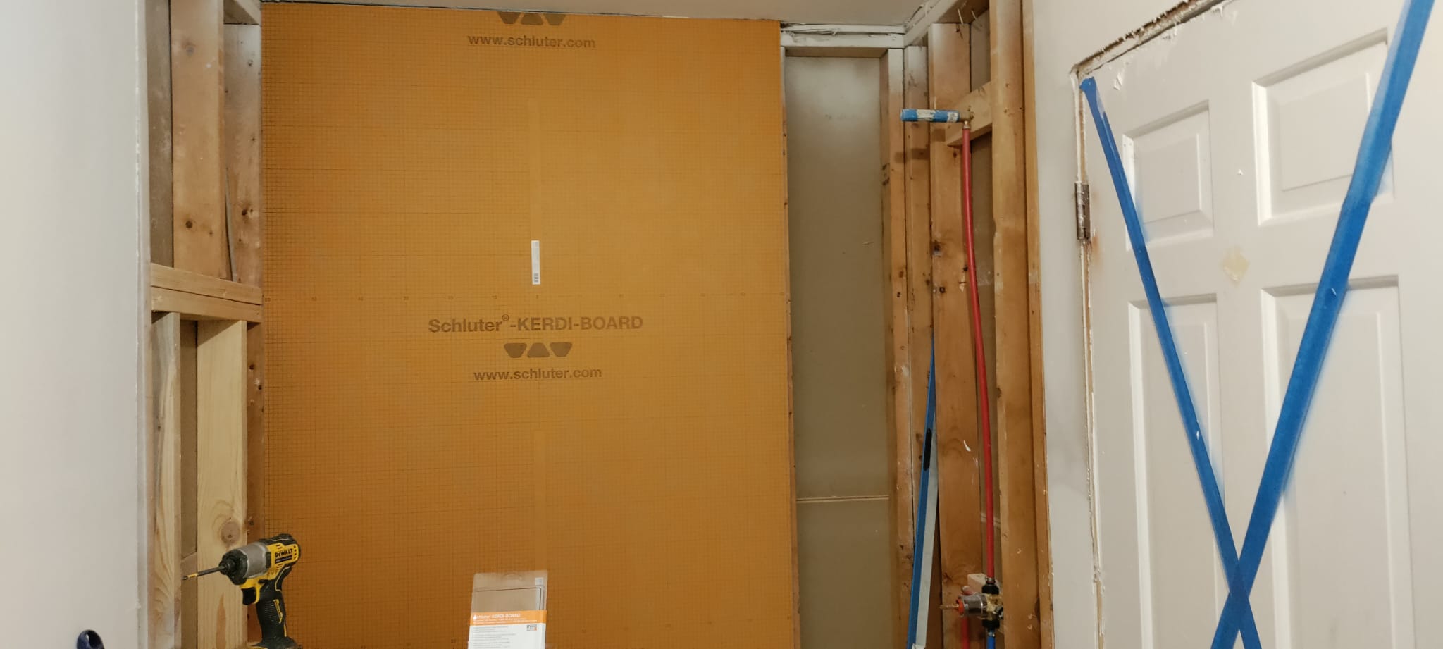 Schluter KERDI-BOARD waterproof shower wall panel with PEX rough-in plumbing lines and stud framing by Roberto Vicente in Spartanburg SC