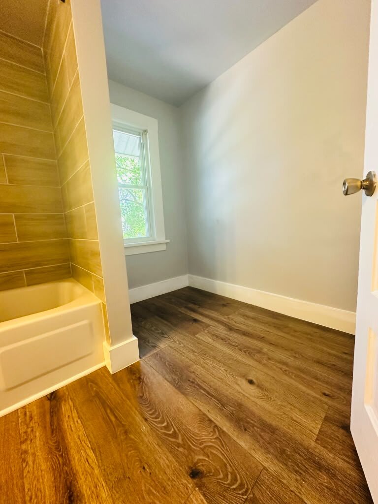 Bathroom with wood floor and natural window light