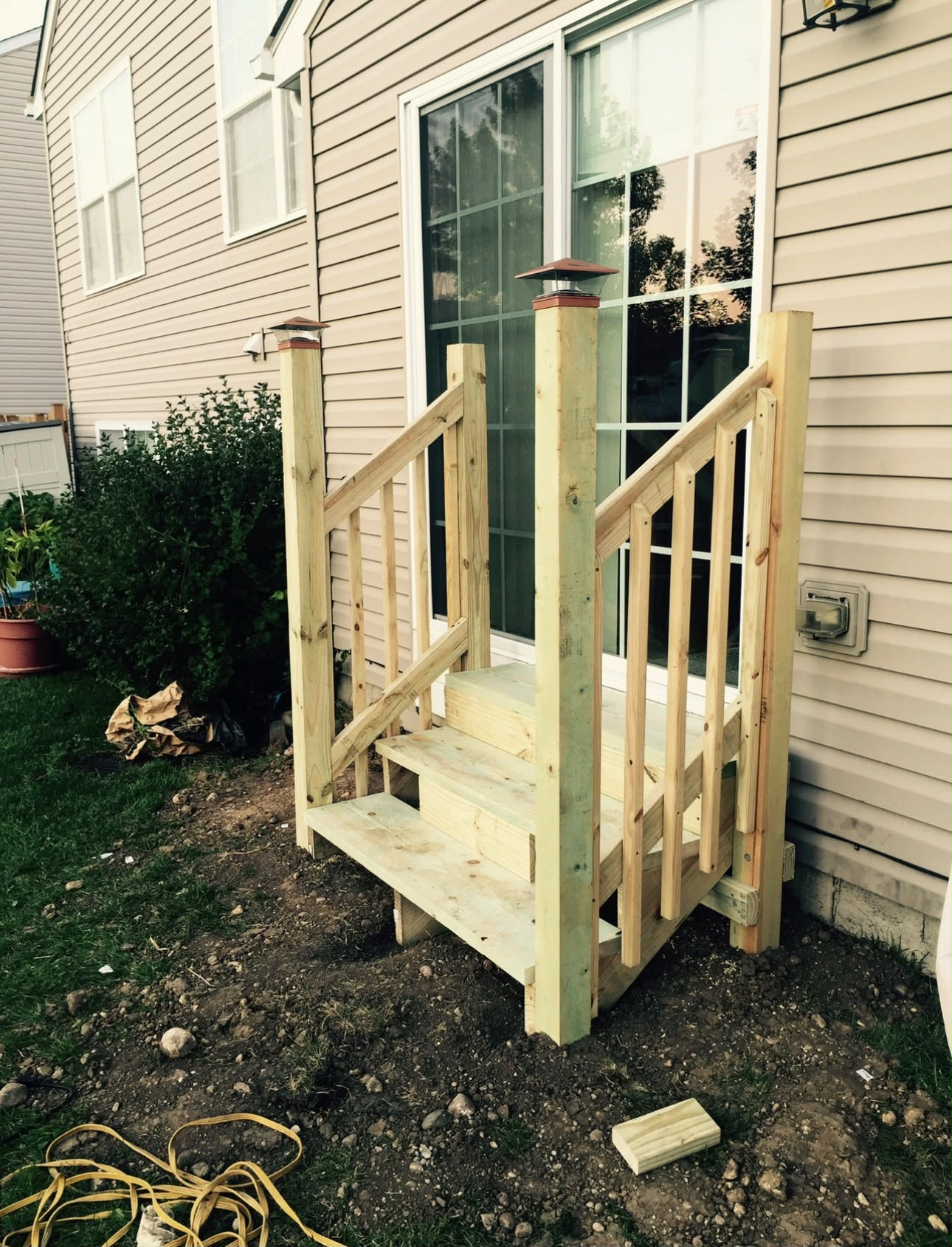 Custom treated wood exterior deck stairs with post lighting