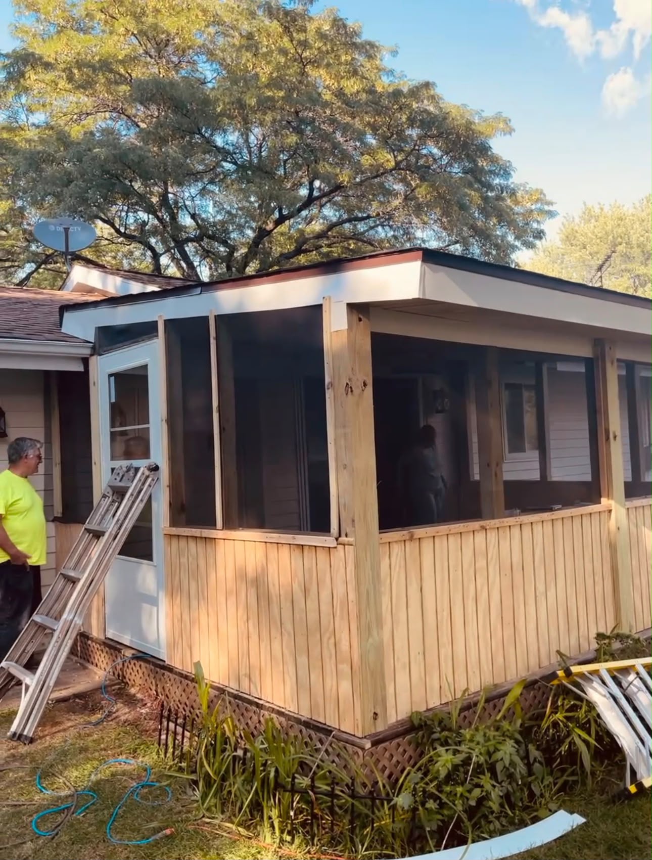 Custom screened-in porch with wood siding buildout