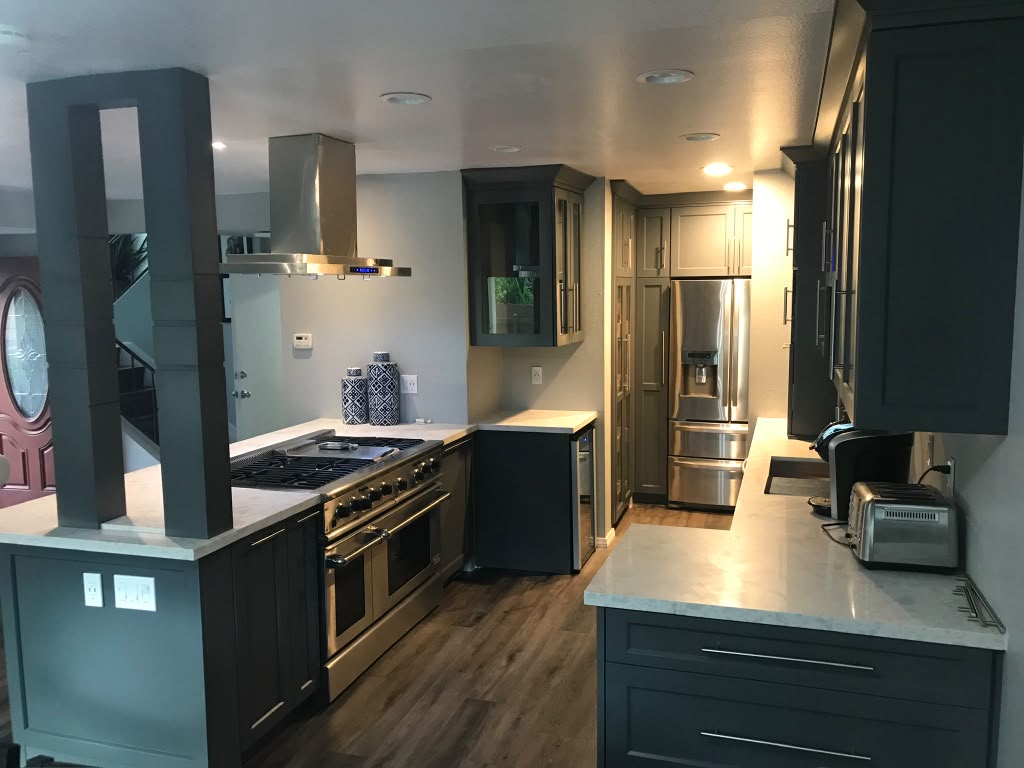 Contemporary slate charcoal kitchen remodel with custom peninsula, stainless steel vent hood, and quartz countertops in Coronado CA
