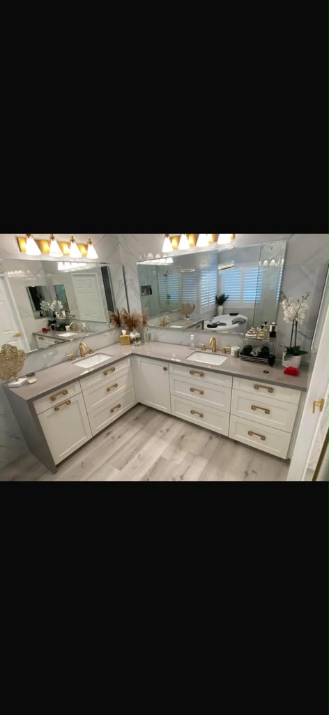Custom L-shaped dual sink master bath vanity with quartz counters and brass pulls by Custom Cabinets San Diego