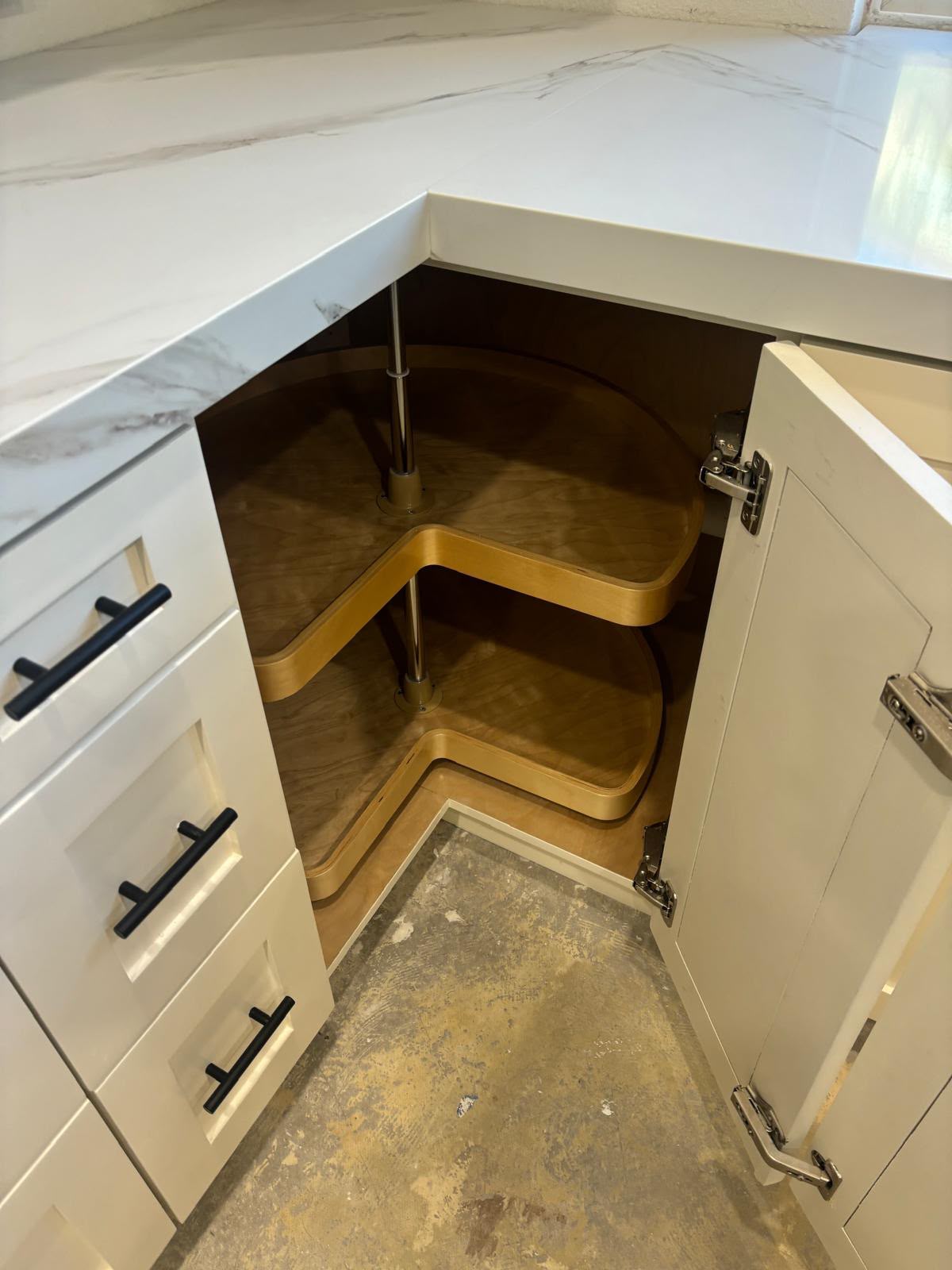 Custom corner kitchen base cabinet with two-tier solid wood revolving lazy Susan and bi-fold hinges in Chula Vista CA