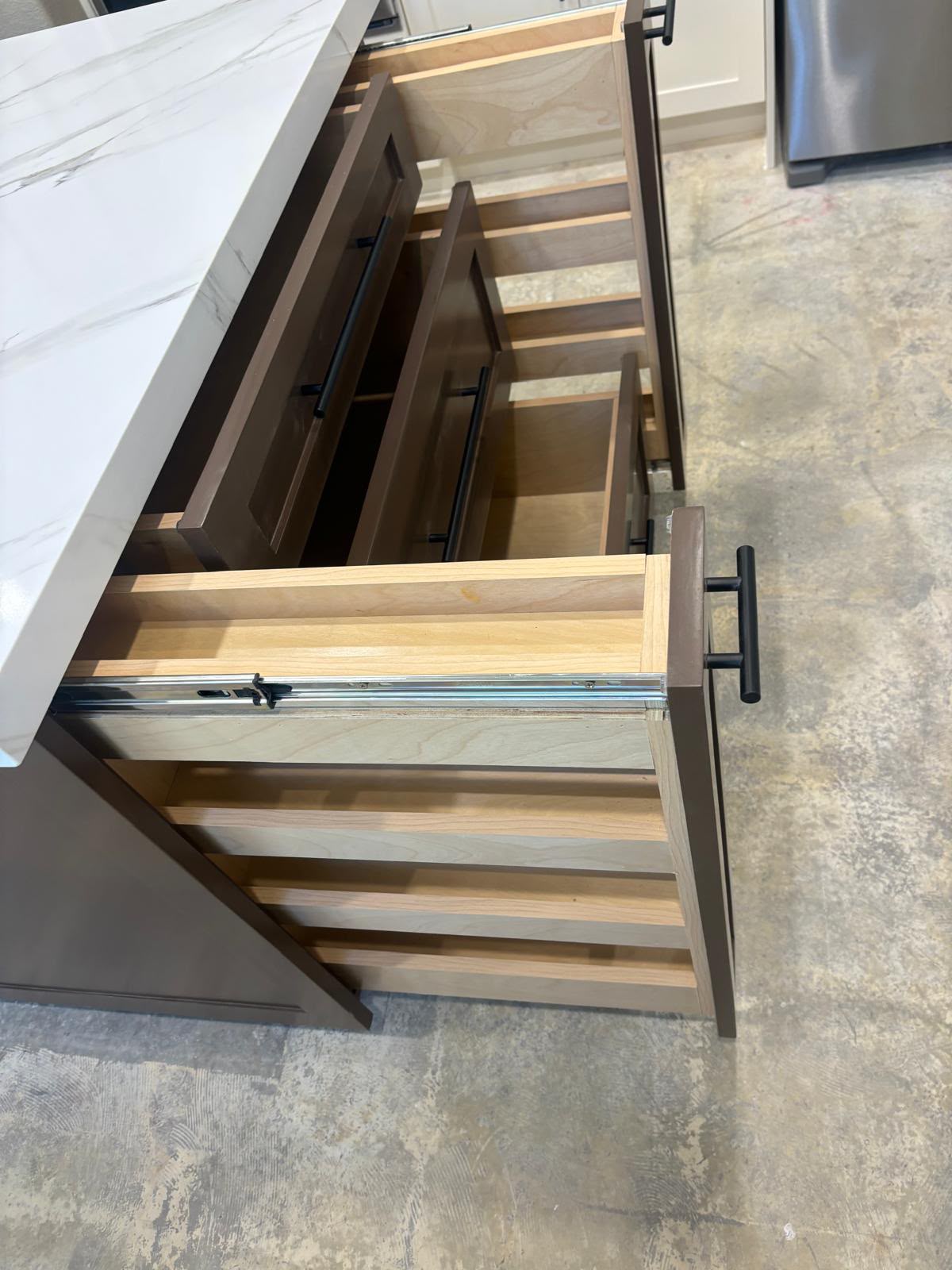 Custom kitchen island pull-out spice rack and soft-close drawers by Custom Cabinets San Diego