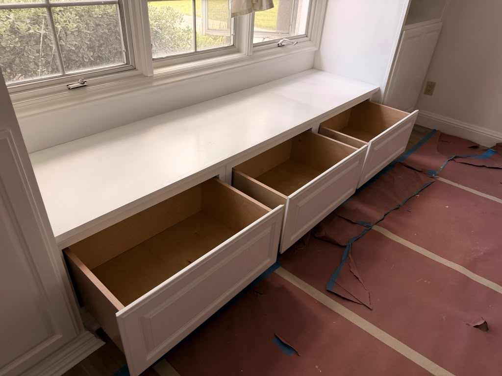 Custom window seat bench with deep dovetail pull-out storage drawers in Bonita CA