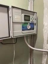 Irrigation controller installed on a wall with wiring run through conduit