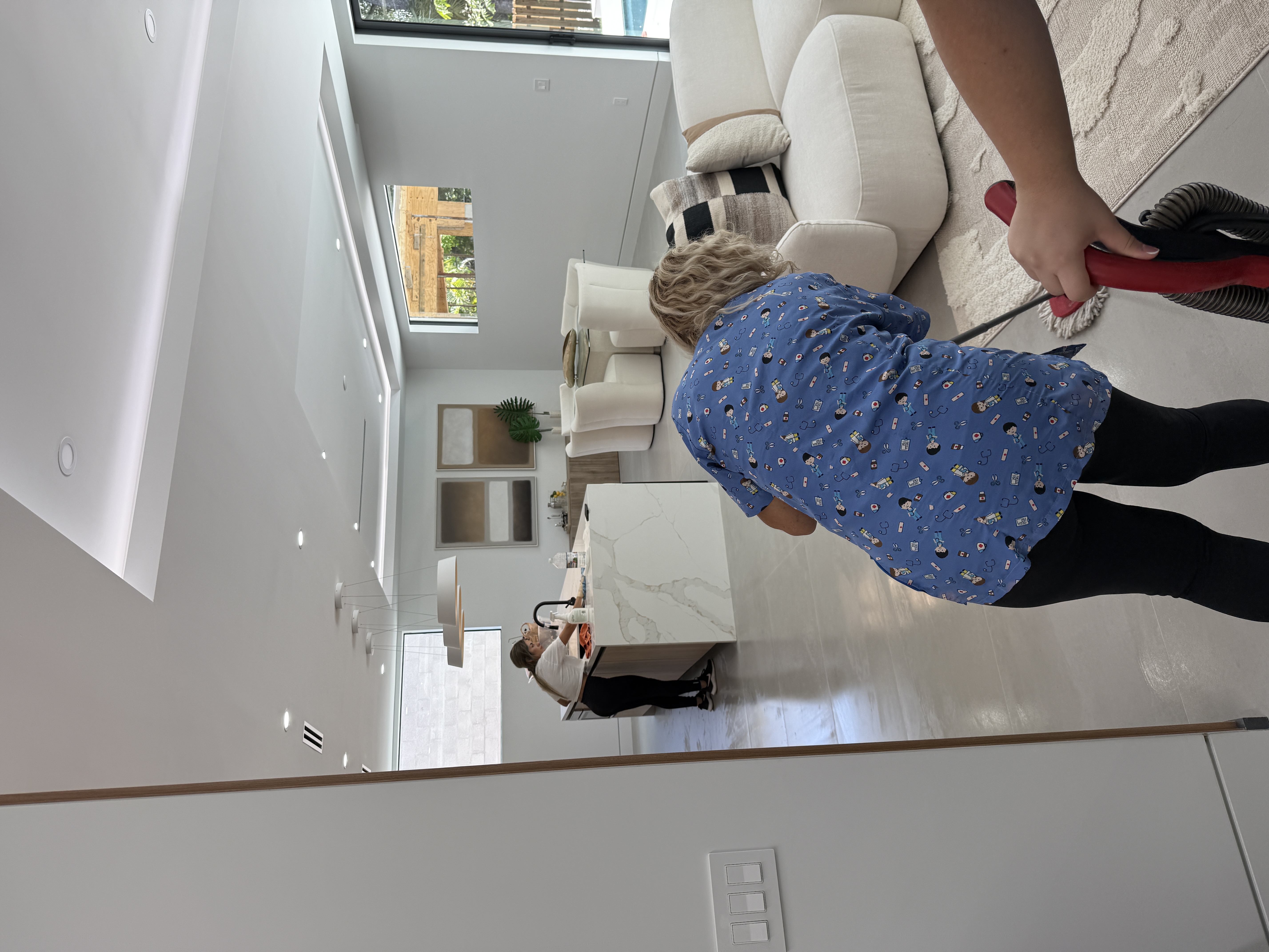 Mojo cleaner vacuuming luxury home living room