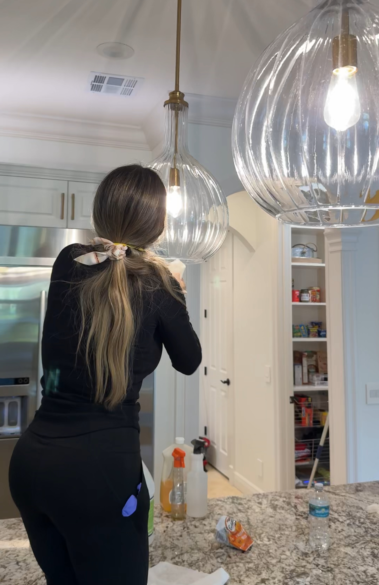 Mojo team cleaning kitchen light fixture