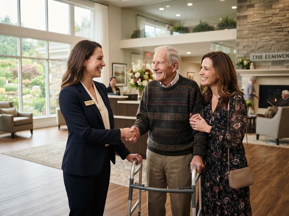 Sales director warmly greeting an adult daughter and her father in a senior living lobby