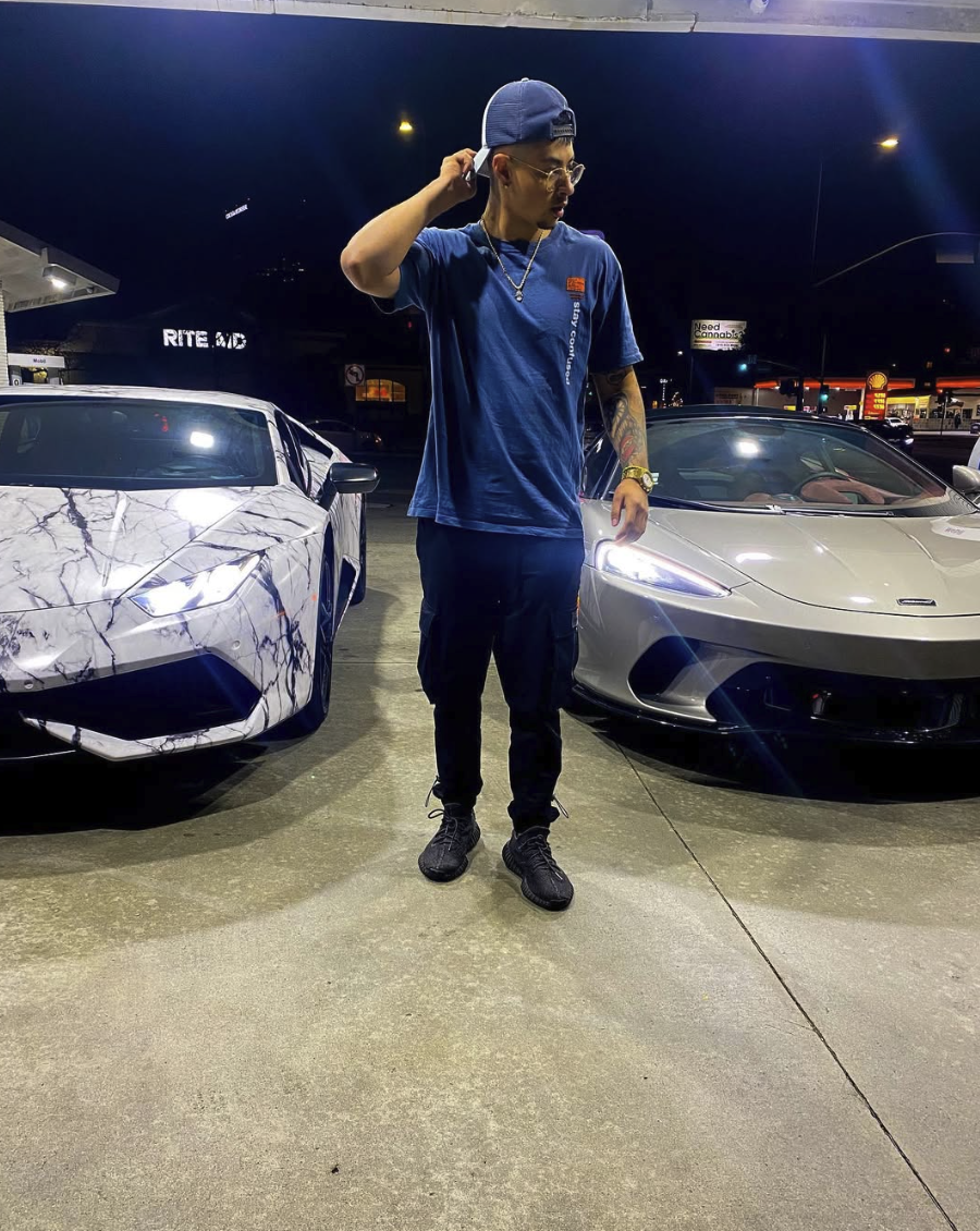 Justin Guerra between marble Lamborghini and McLaren supercars
