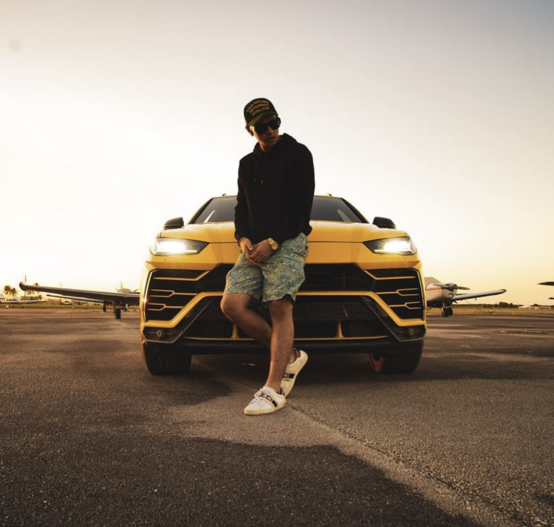 Justin Guerra with yellow Lamborghini Urus on private airport tarmac