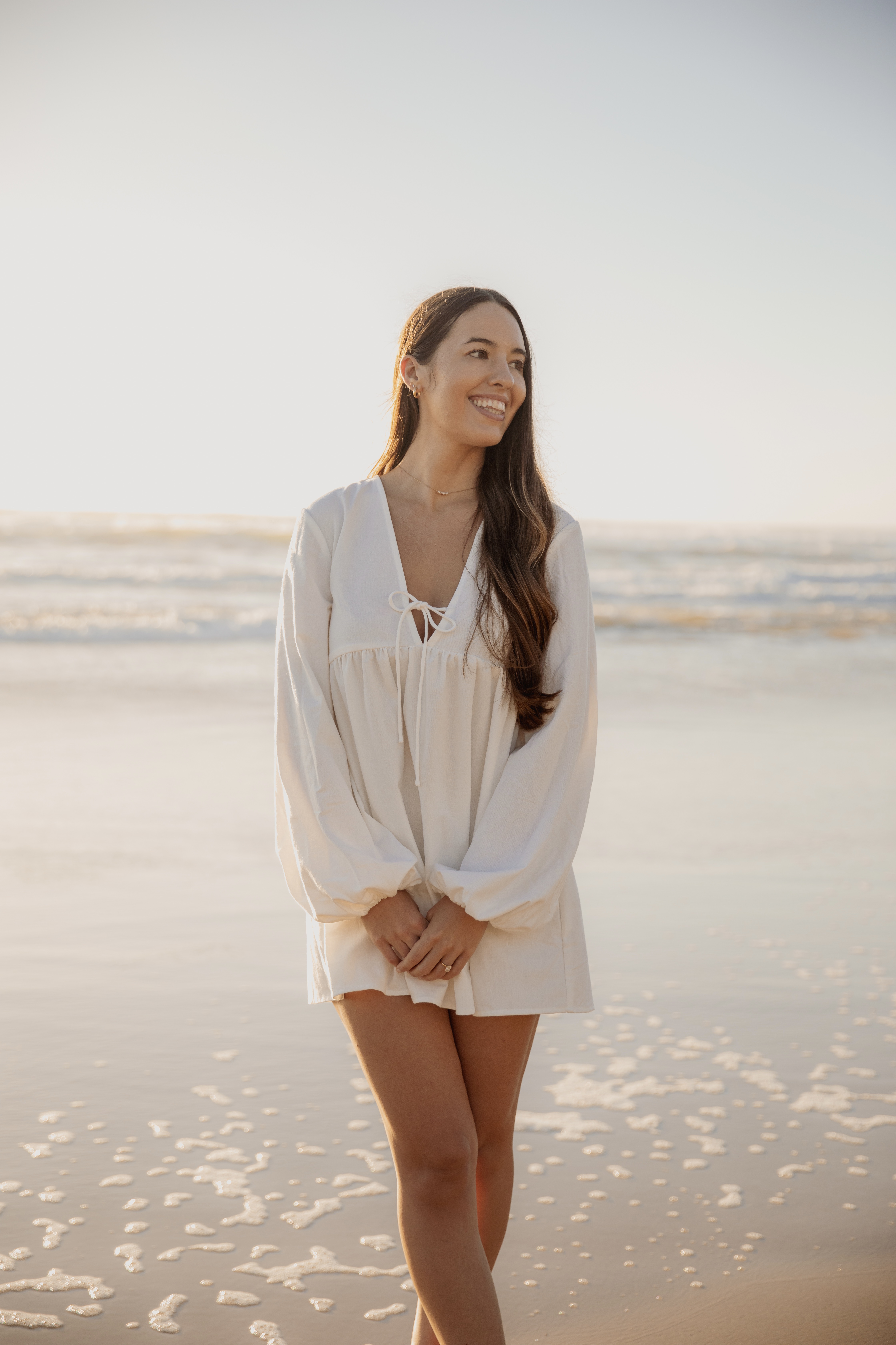 Alia, life and mindset coach, smiling on the beach