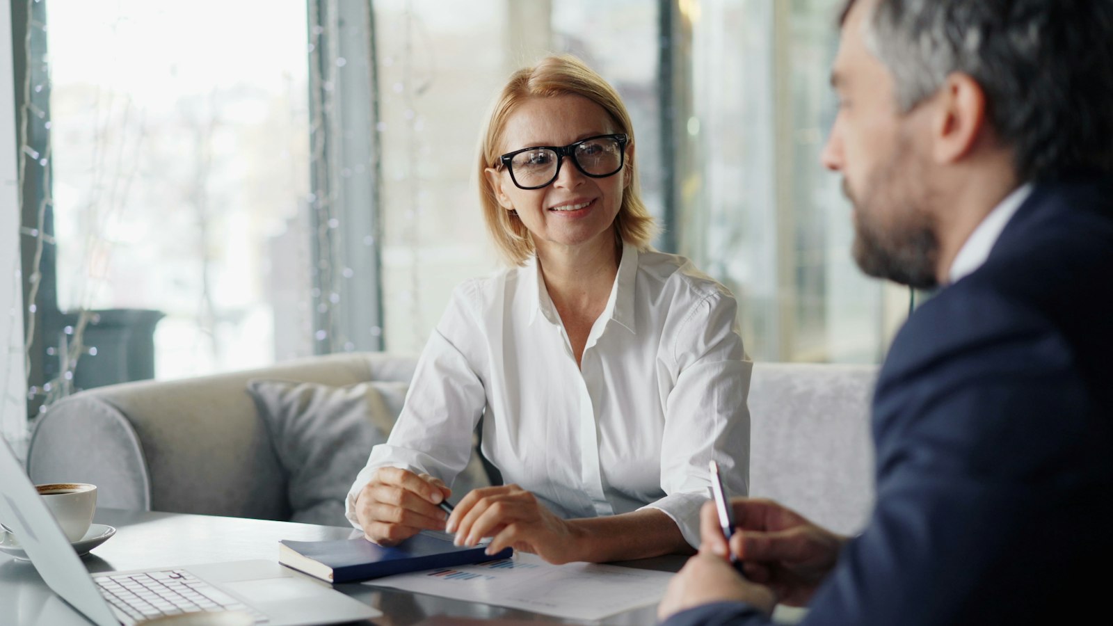 Two healthcare professionals reviewing client care plans together during a consultation