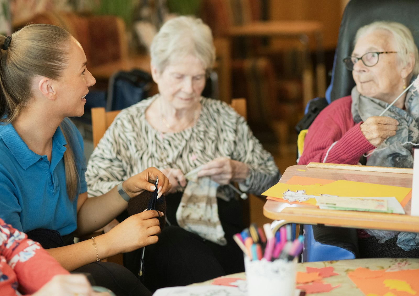 A caregiver respectfully assisting older adults with a meaningful daily activity at home