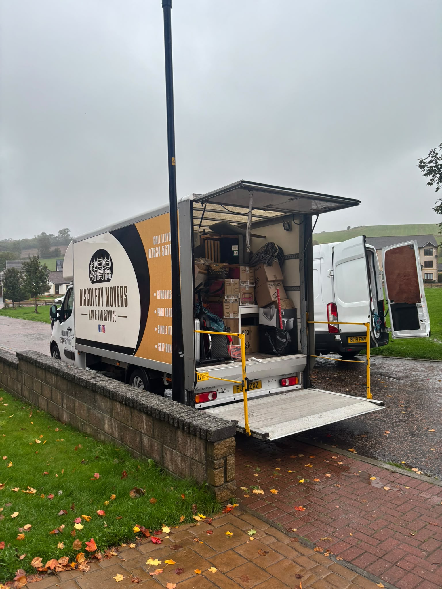 Discovery Movers removal truck loaded with boxes and furniture with tail lift lowered