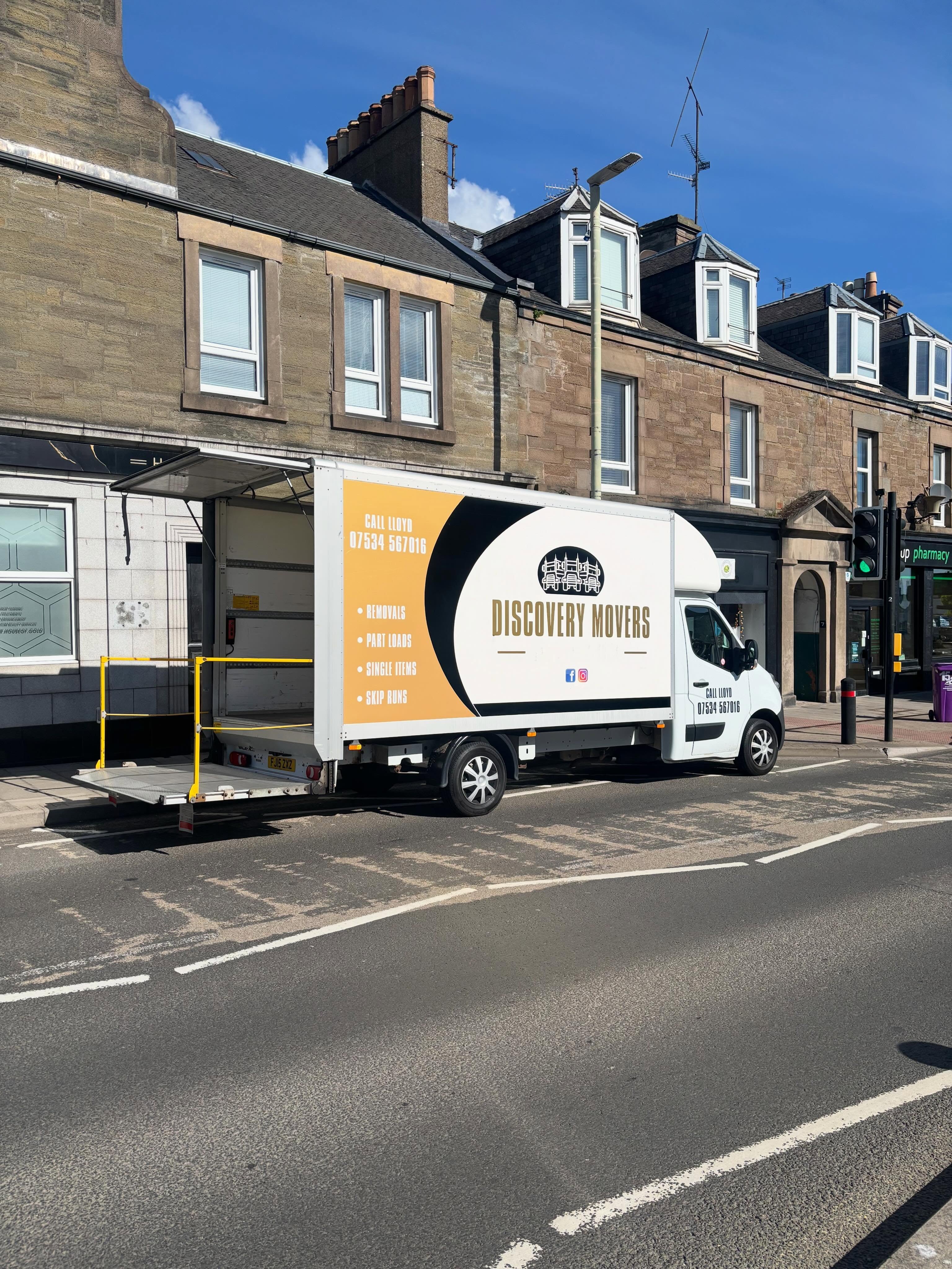 Discovery Movers removal truck with tail-lift ready on the street