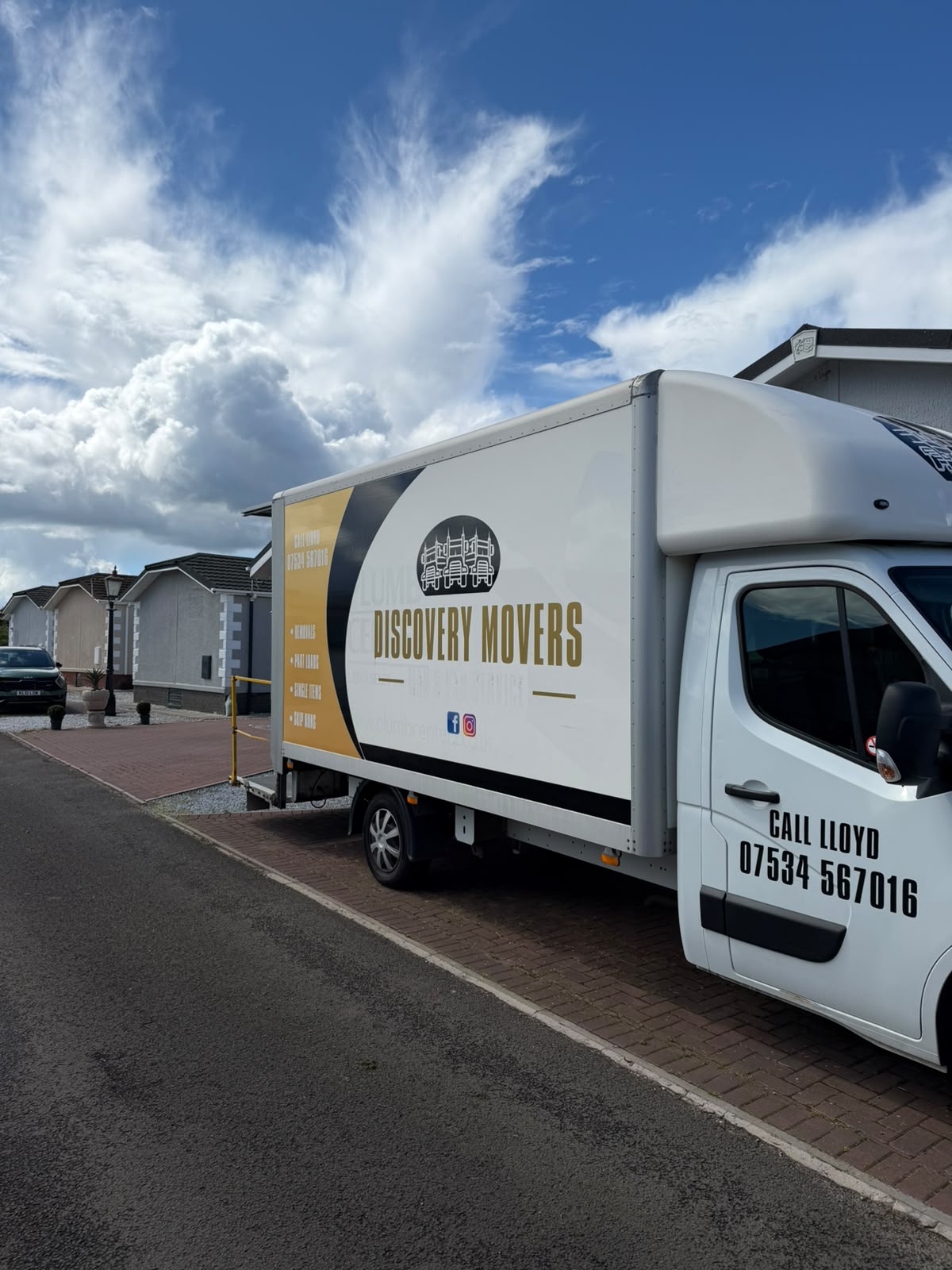 Discovery Movers removal van parked outside homes on a residential street in Angus
