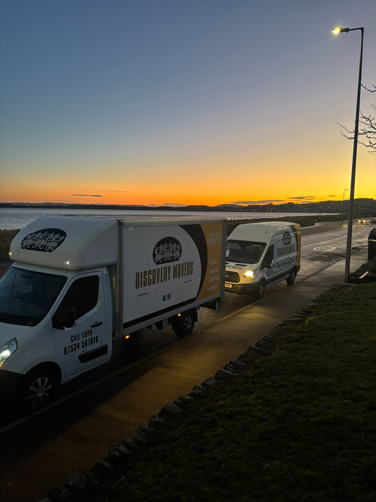 Discovery Movers vans on the road across Tayside at sunset