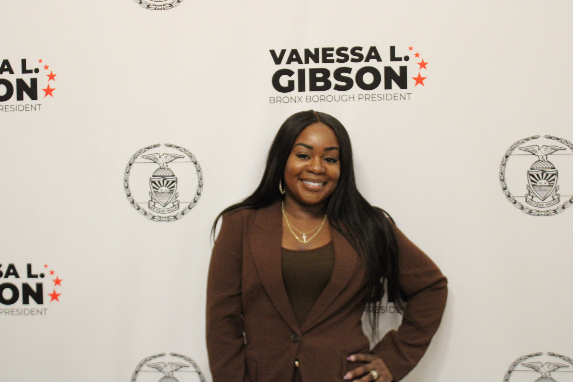 Taje on red carpet step-and-repeat at civic gala