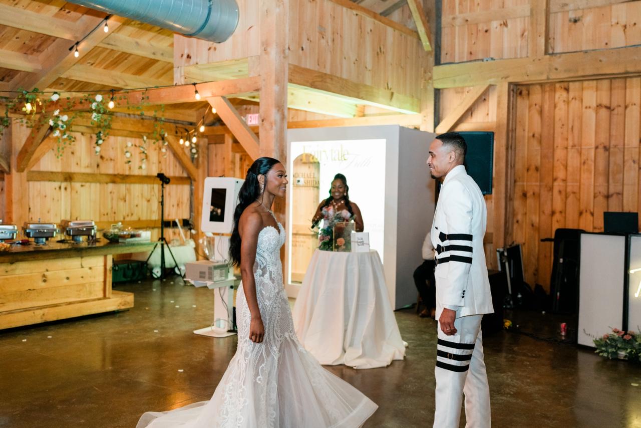 Taje hosting at the wedding reception as the bride and groom meet on the floor