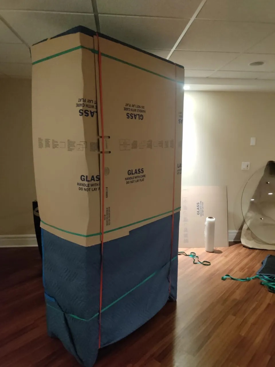 Tall glass cabinet fully boxed in cardboard and blankets for a Chicago move