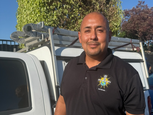 Ernesto Acosta with Hub City Electric truck in Compton, CA