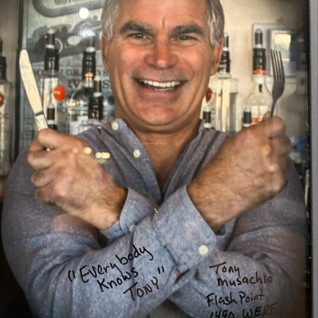 Tony Musachio holding a fork and knife, Cleveland's roving restaurant reporter