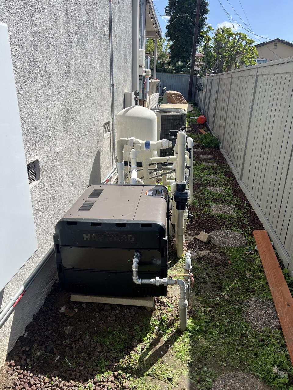 New Hayward pool heater installation on residential equipment pad