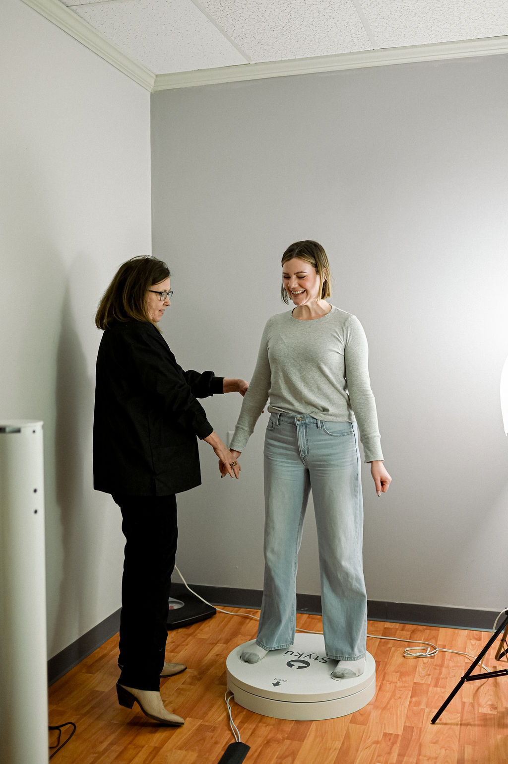 Client receiving personalized Styku 3D body scan consultation at Body Lyft System Carmel