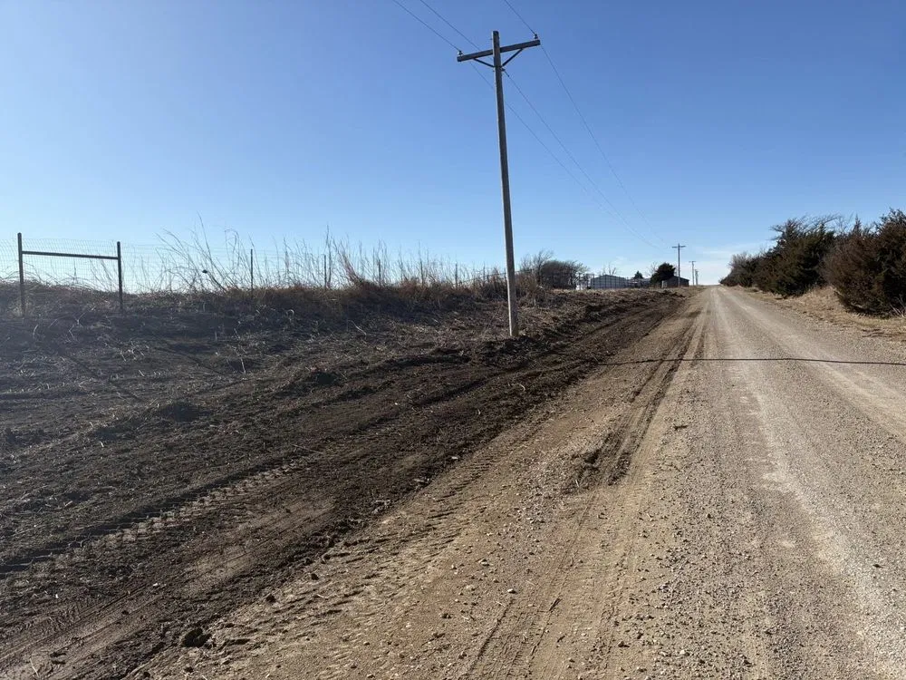 Freshly graded ground along a gravel road