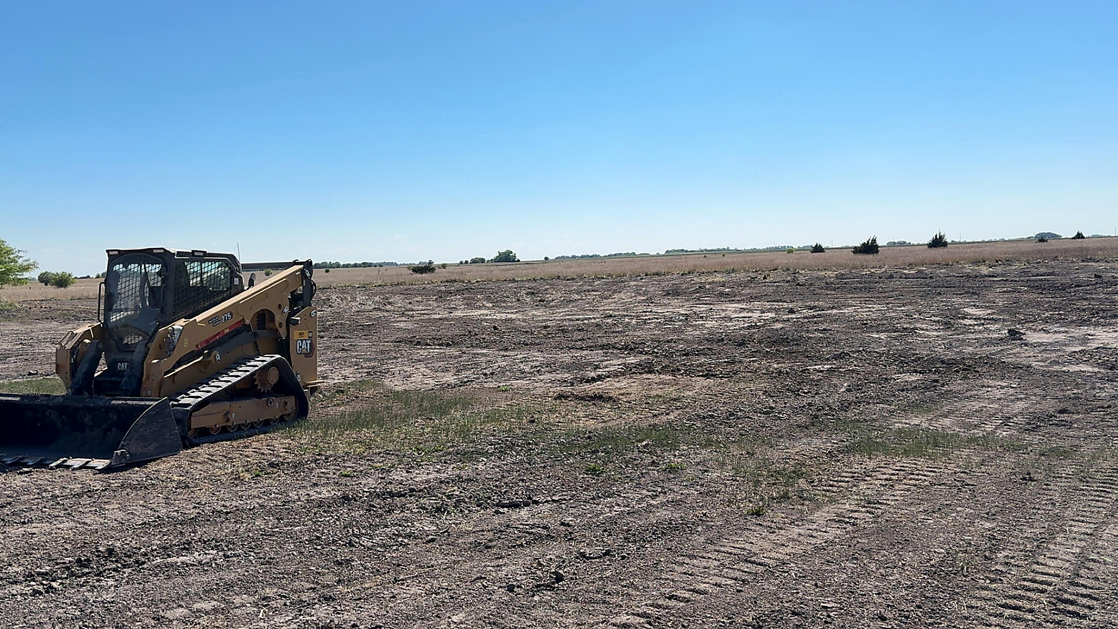 CAT compact track loader grading bare ground