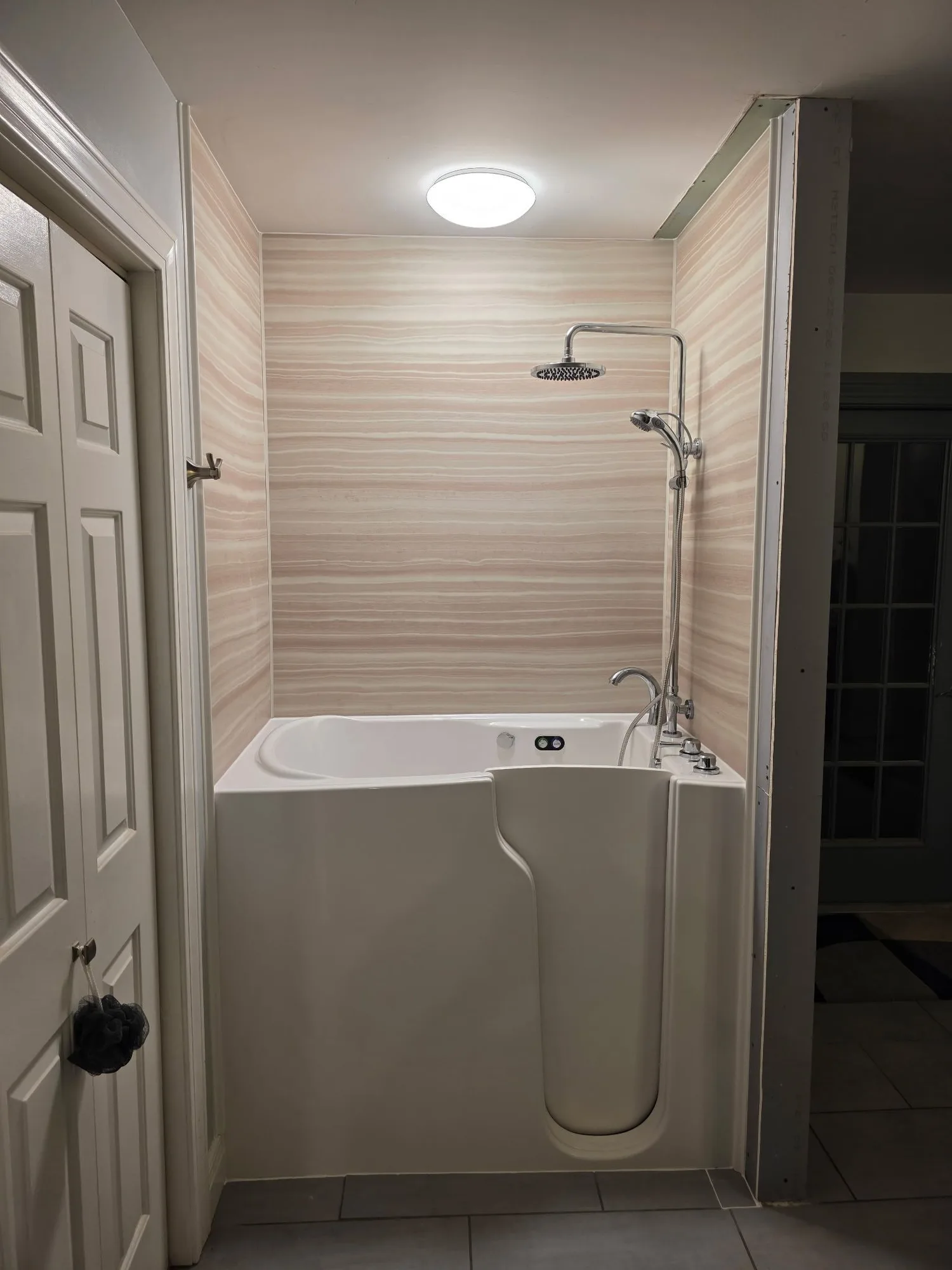 H&H Home & Bath Renovations completed accessible walk-in soaking tub and shower remodel with wall surround and chrome fixtures