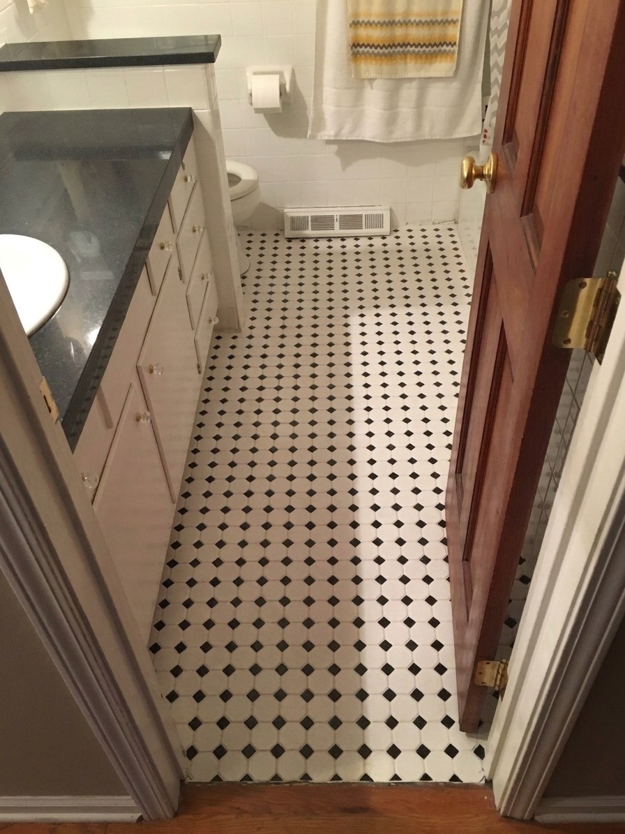 H&H Home & Bath Renovations completed classic black and white diamond pattern tile bathroom flooring installation