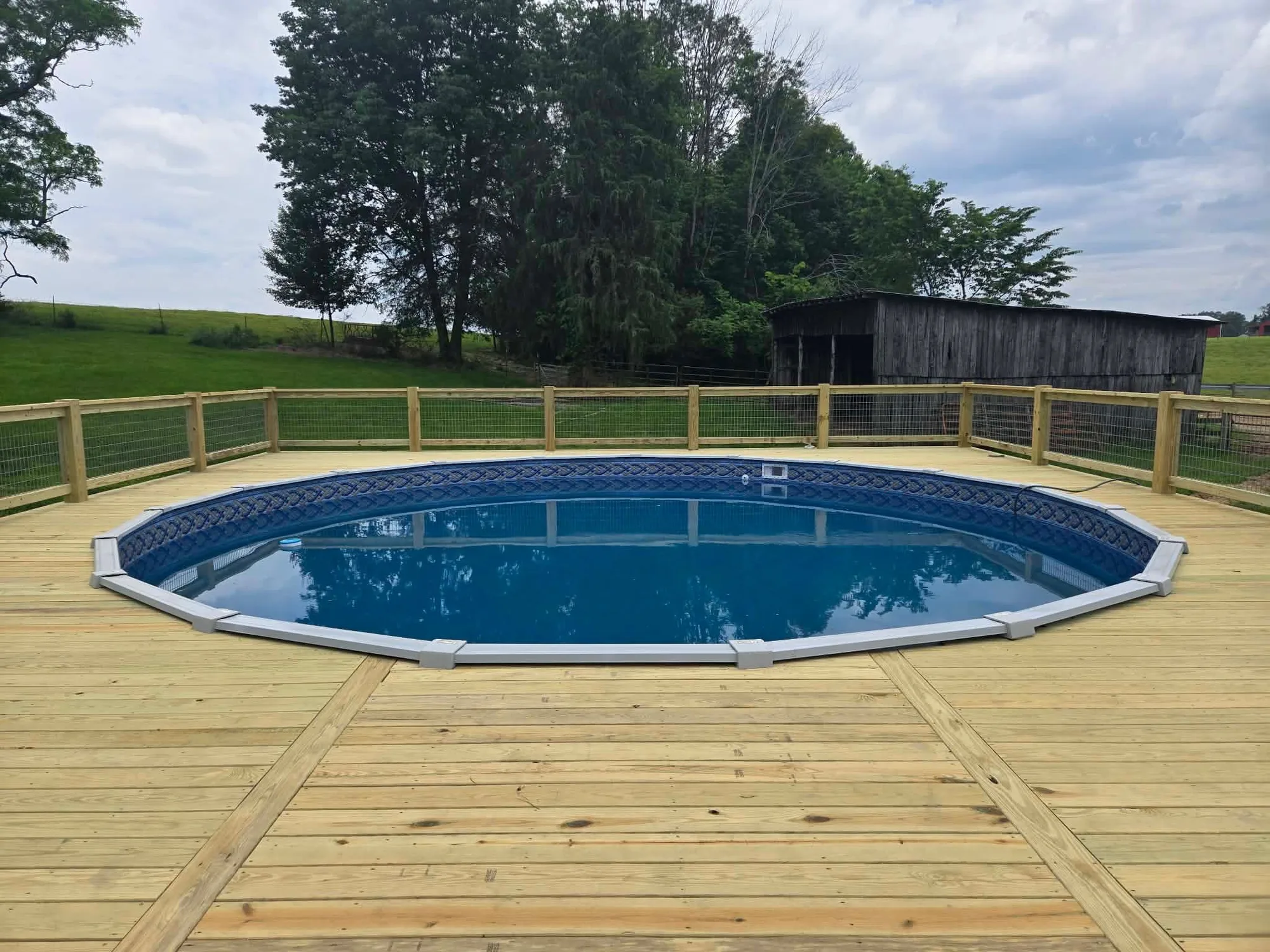 H&H Home & Bath Renovations custom built wraparound pool deck with safety rail and wire fencing