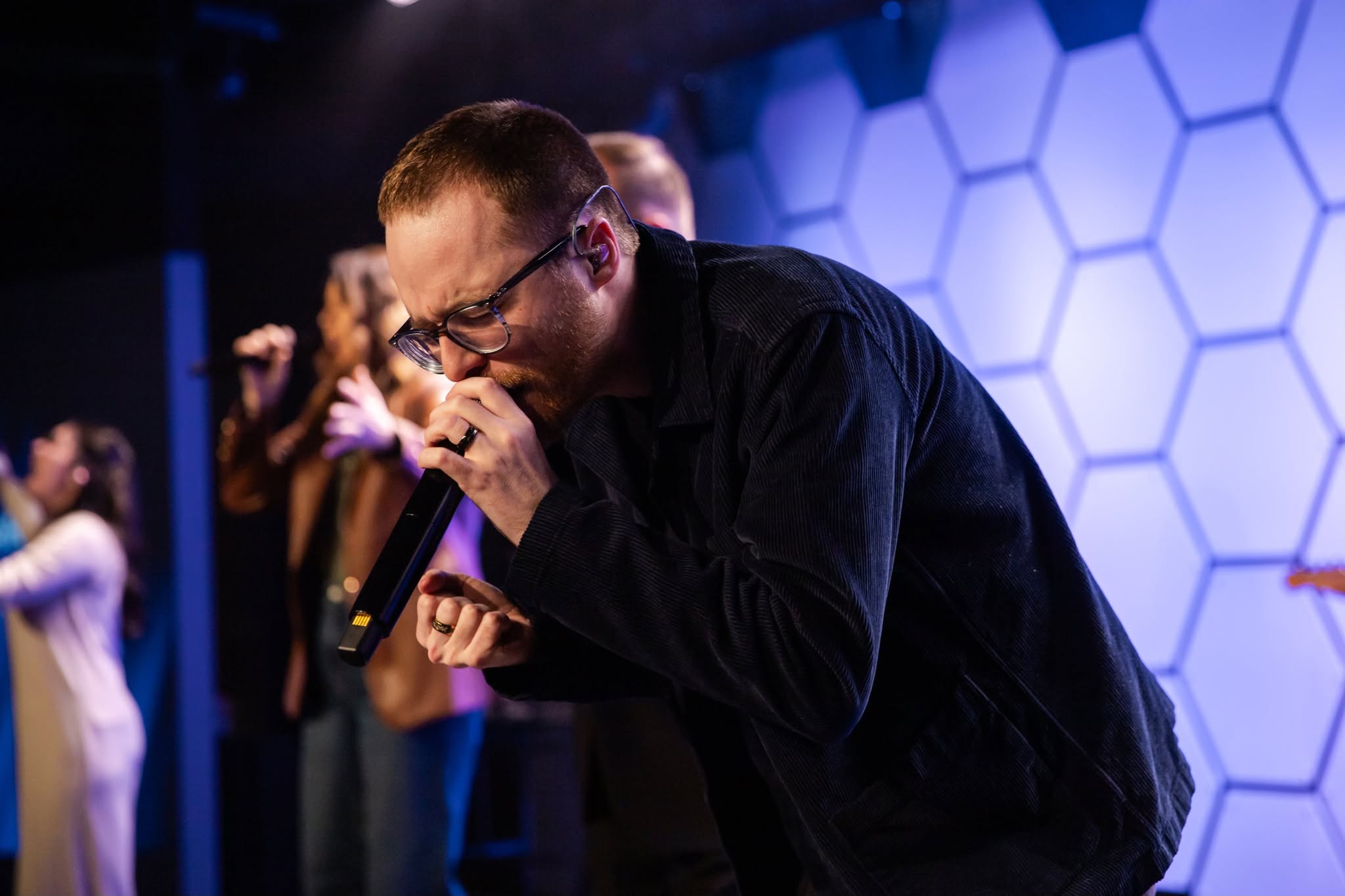 Worship leader singing into the microphone