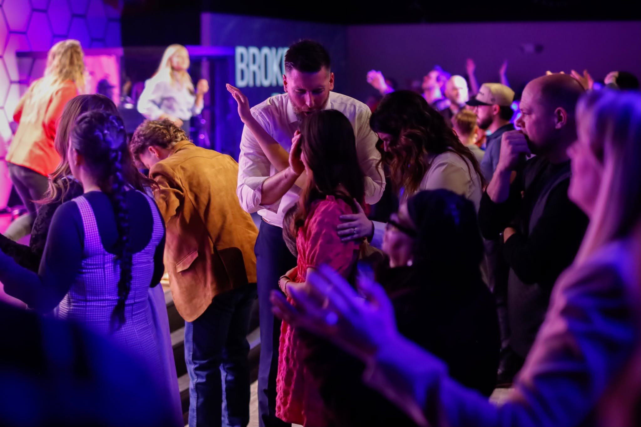 Ministers laying hands on one another in prayer and fellowship