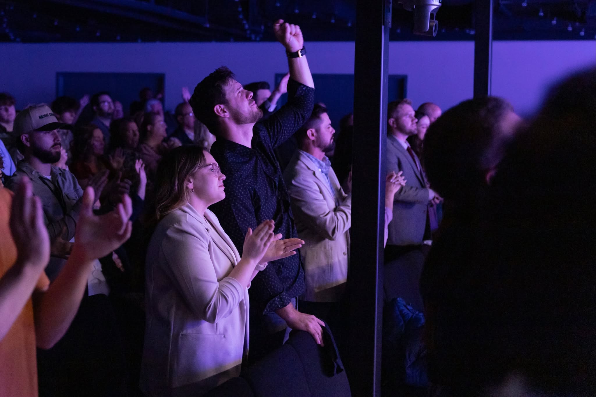 Men and women worshiping together across generations