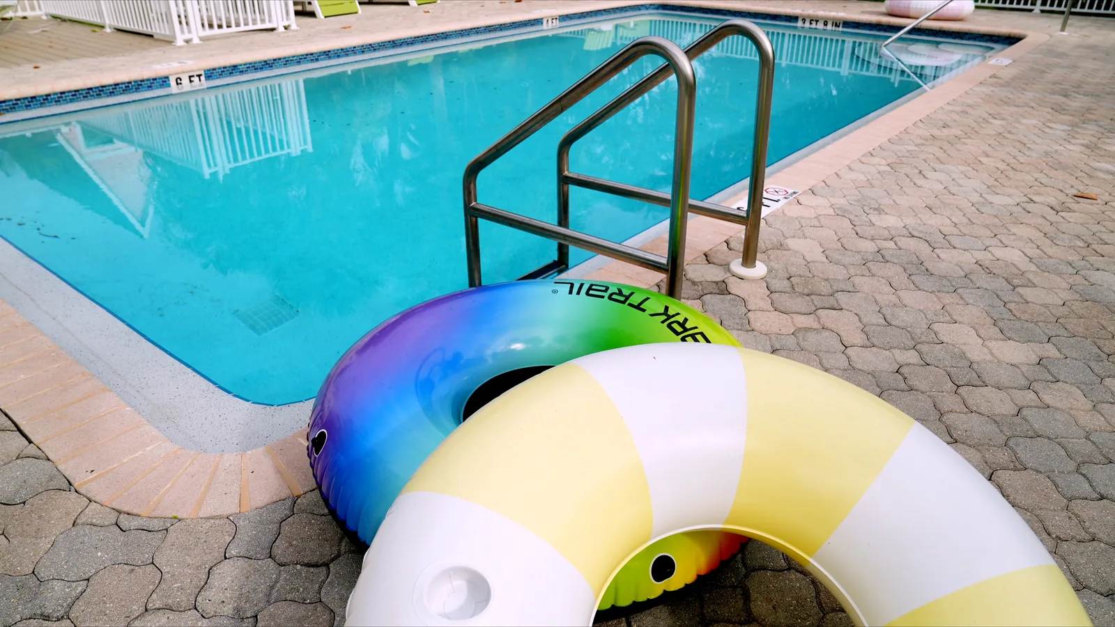 Pool tile and coping along the waterline of a maintained pool