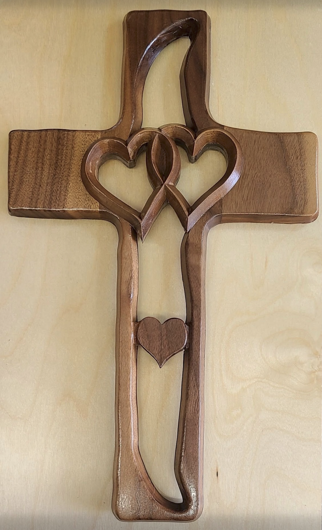 Handcrafted carved walnut cross with intertwined hearts
