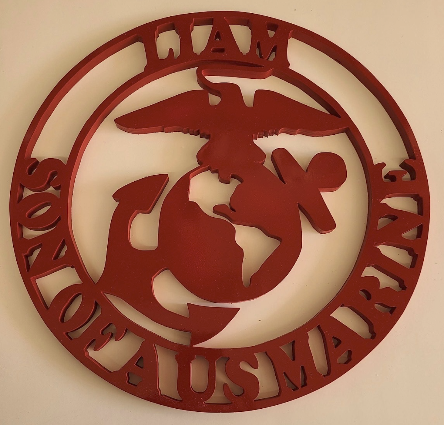 Handcrafted 'Son of a US Marine' circular scroll saw emblem in bold red