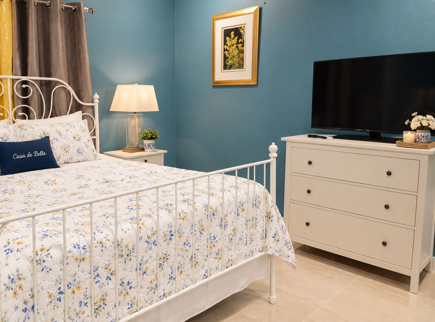 Comfortable studio bedroom space with bright blue accent