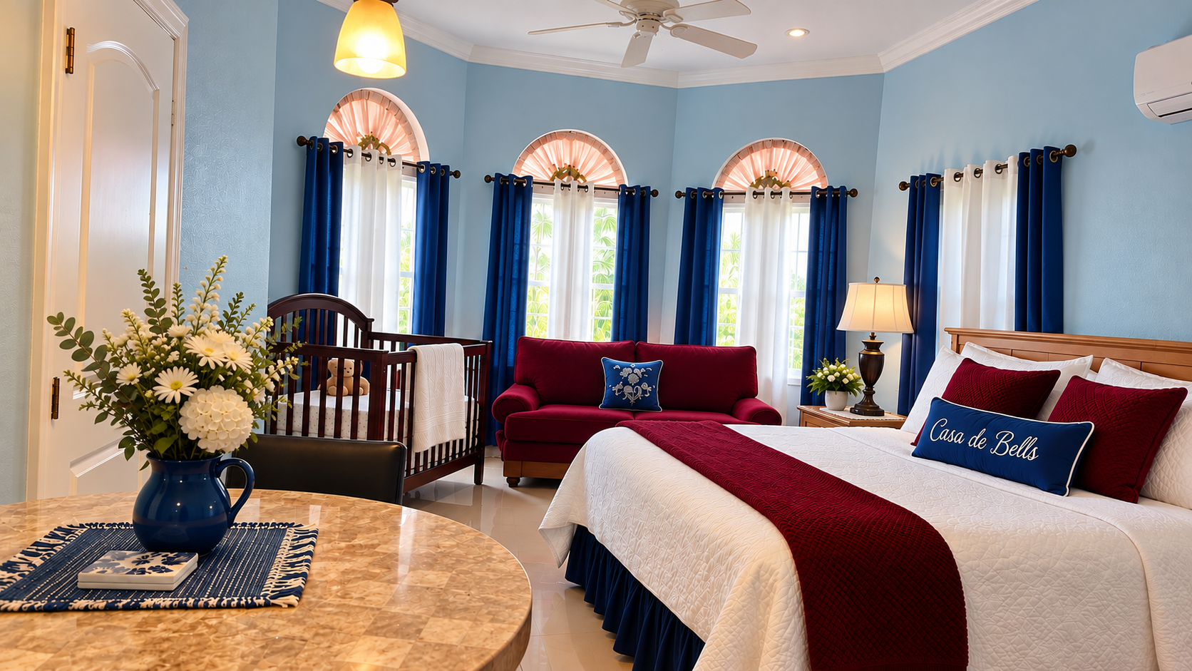 Spacious studio suite with king bed, crib, seating area, and arched windows