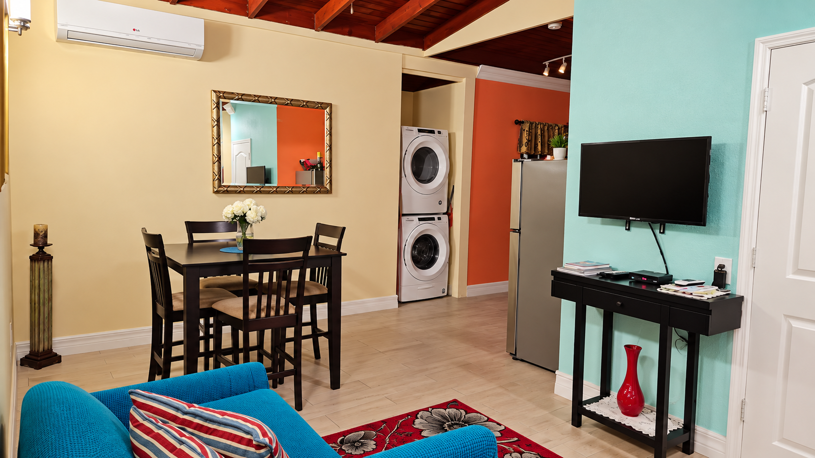 Open dining area with TV and in-unit stackable washer and dryer