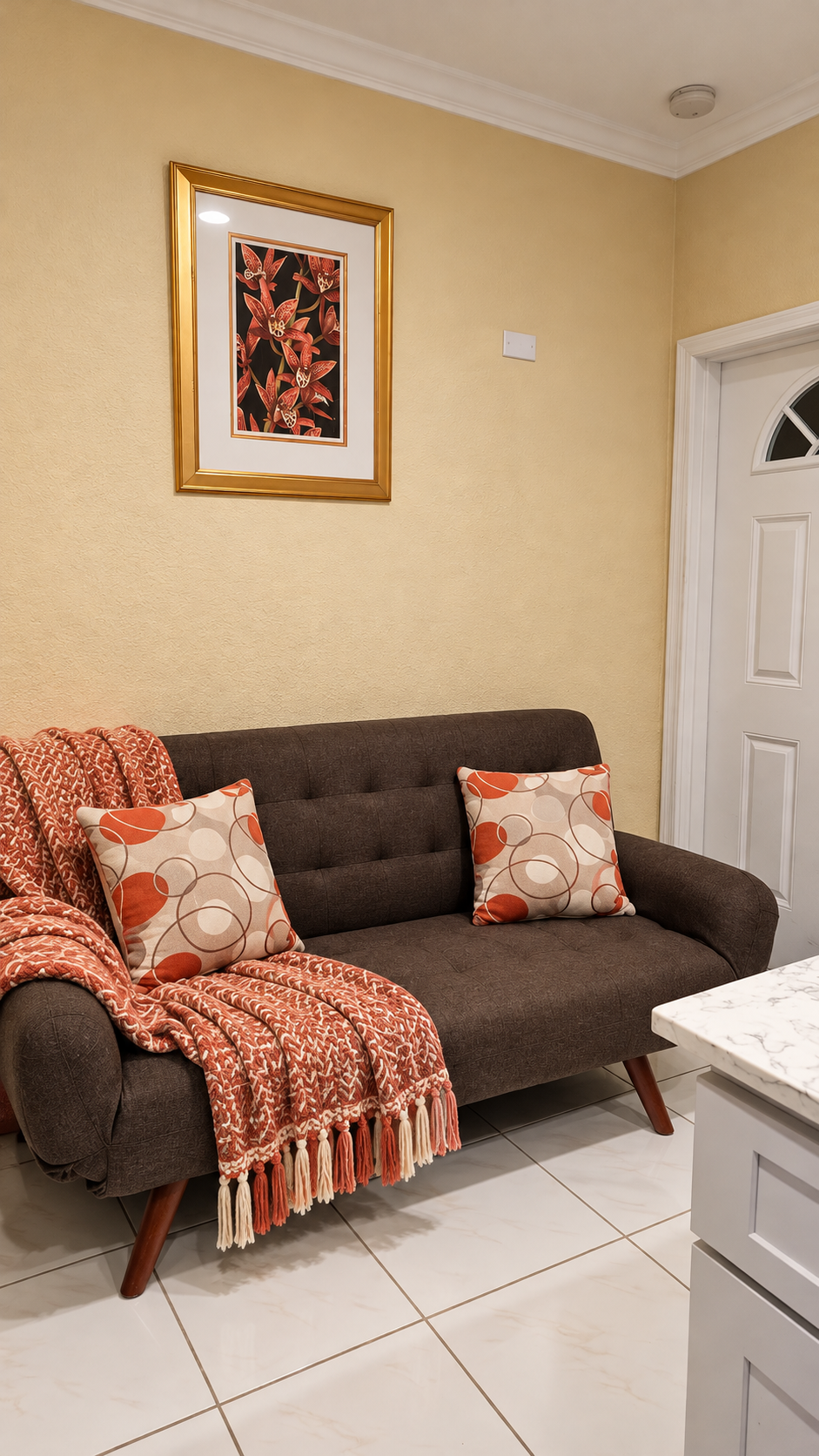 Cozy living room with tufted sofa and warm terracotta accents
