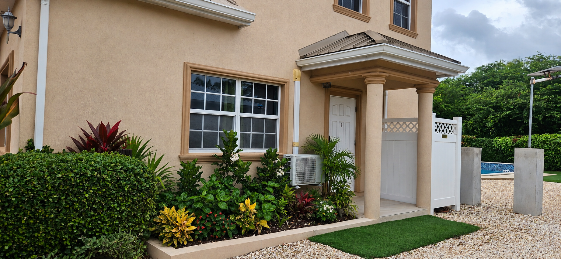 Private entrance to Casa de Bells 3 with portico porch and landscaped tropical garden