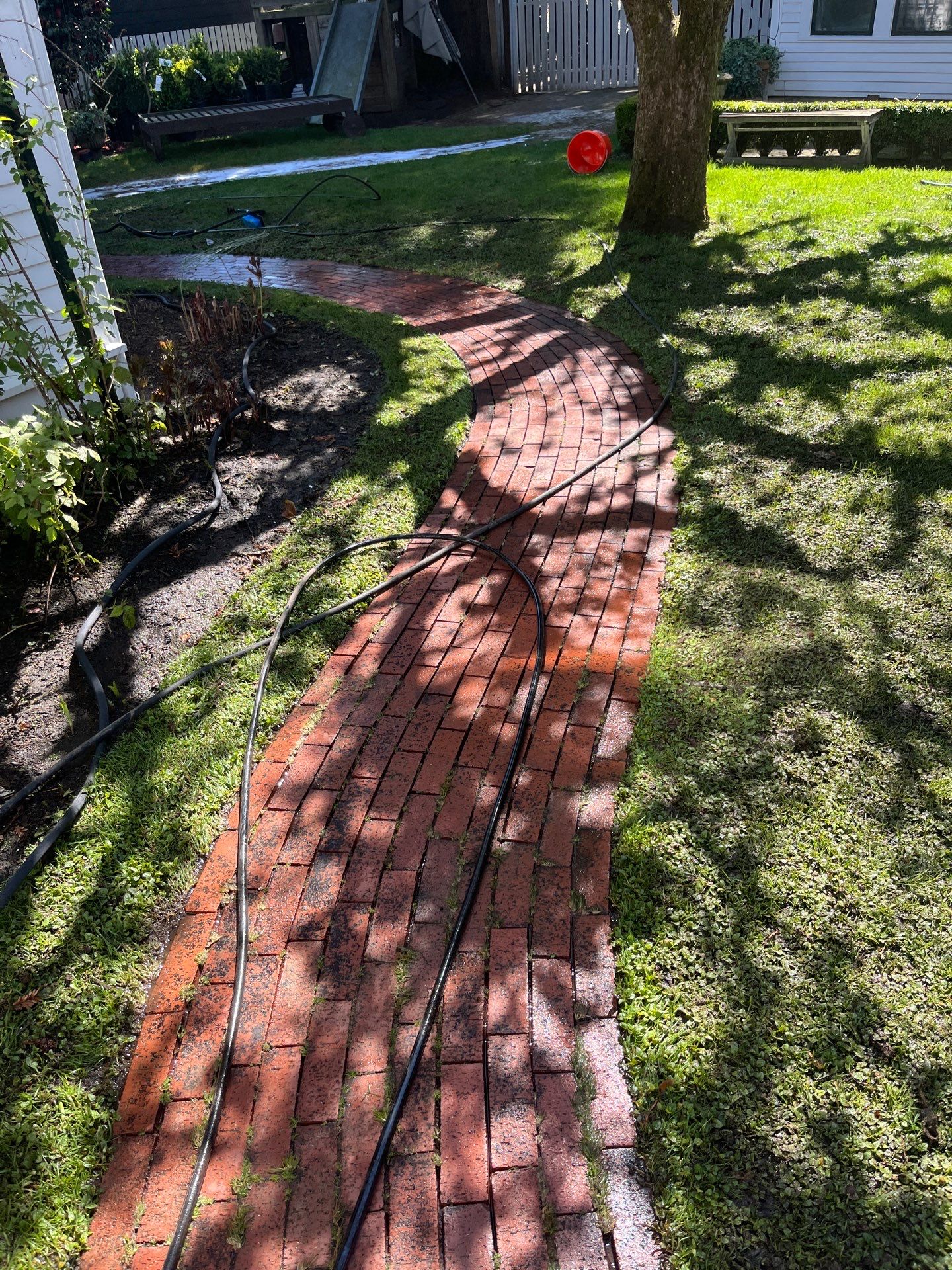 Restored red brick walkway freshly pressure washed by Homeworks Restoration