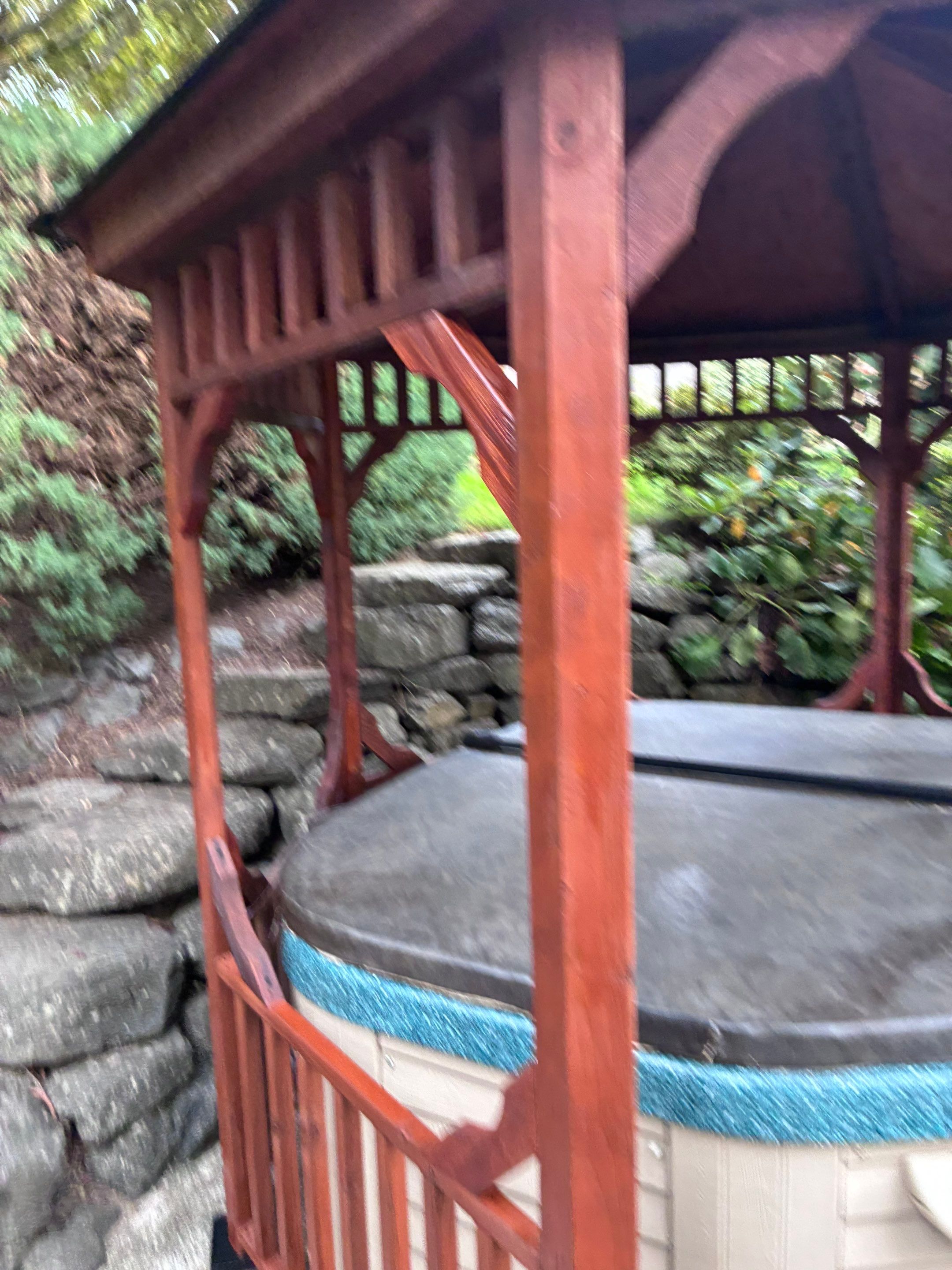 After gazebo restoration — rich protective stain highlighting cedar grain and shielding from moisture