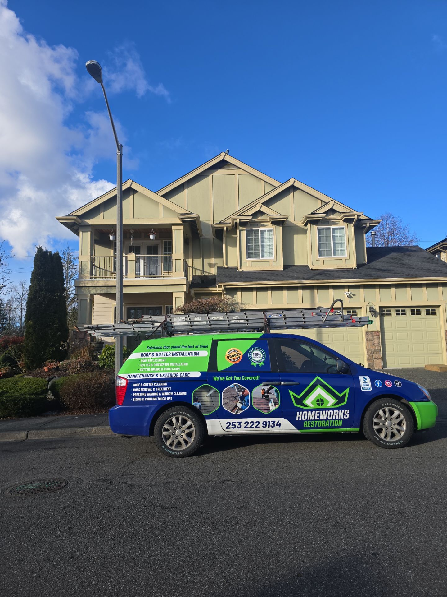 Homeworks Restoration exterior maintenance service van parked in front of a Pacific Northwest home